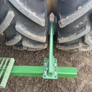 Mud scraper for John Deere X9 combine designed to reduce debris buildup