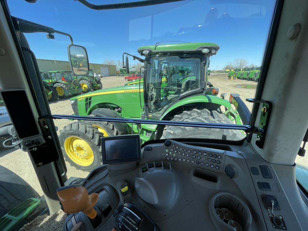 Installed cab rail for monitor mounting in John Deere tractor